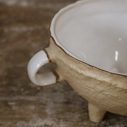 Close-up of handle detail and gold-edged rim of Nosse Ubuntu Bowl